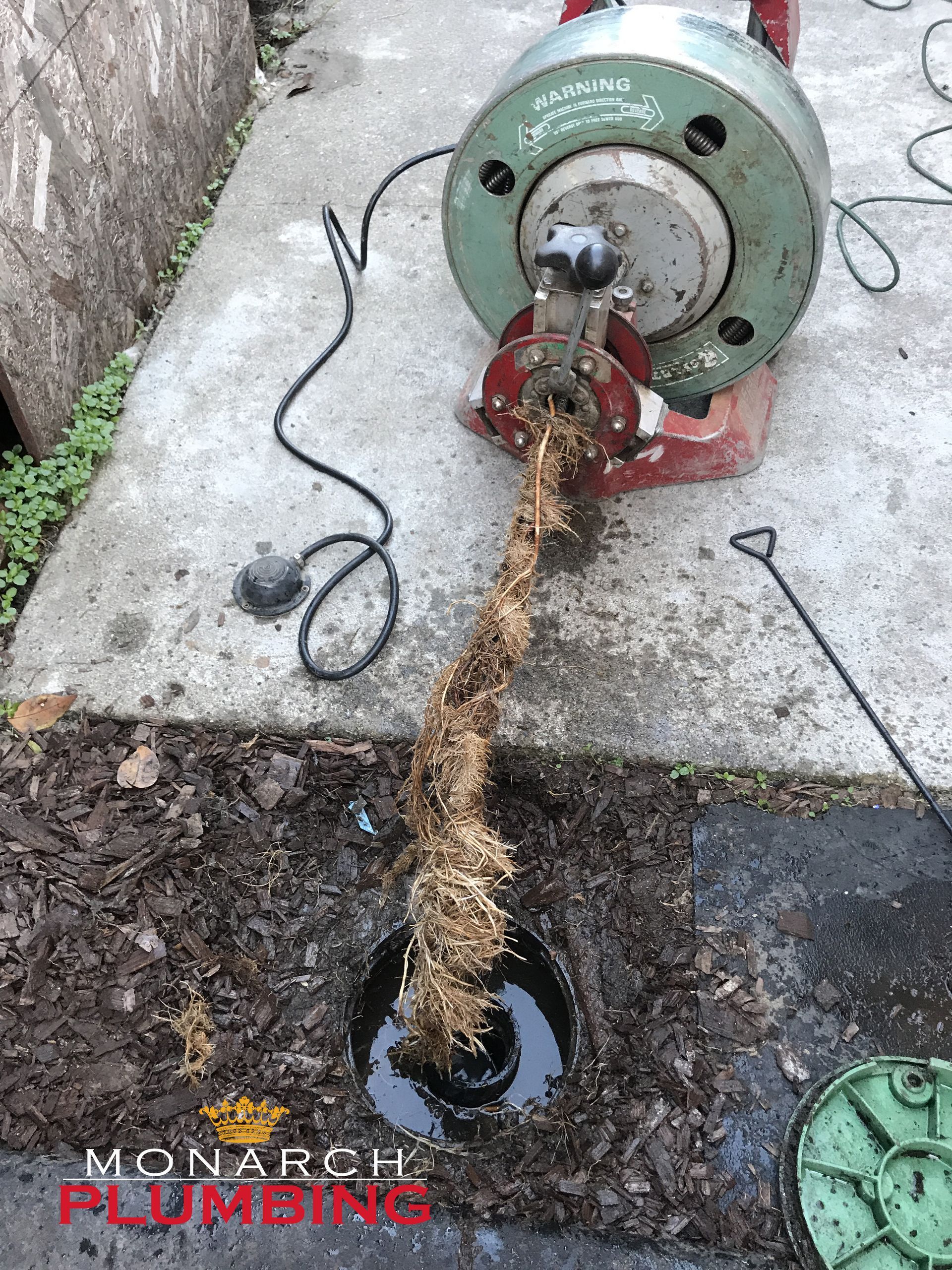 Monarch team performing drain cleaning services in the bay area