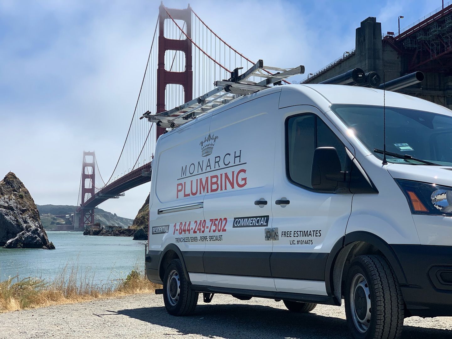 White Monarch plumbing van parked near the Golden Gate Bridge by the waterfront