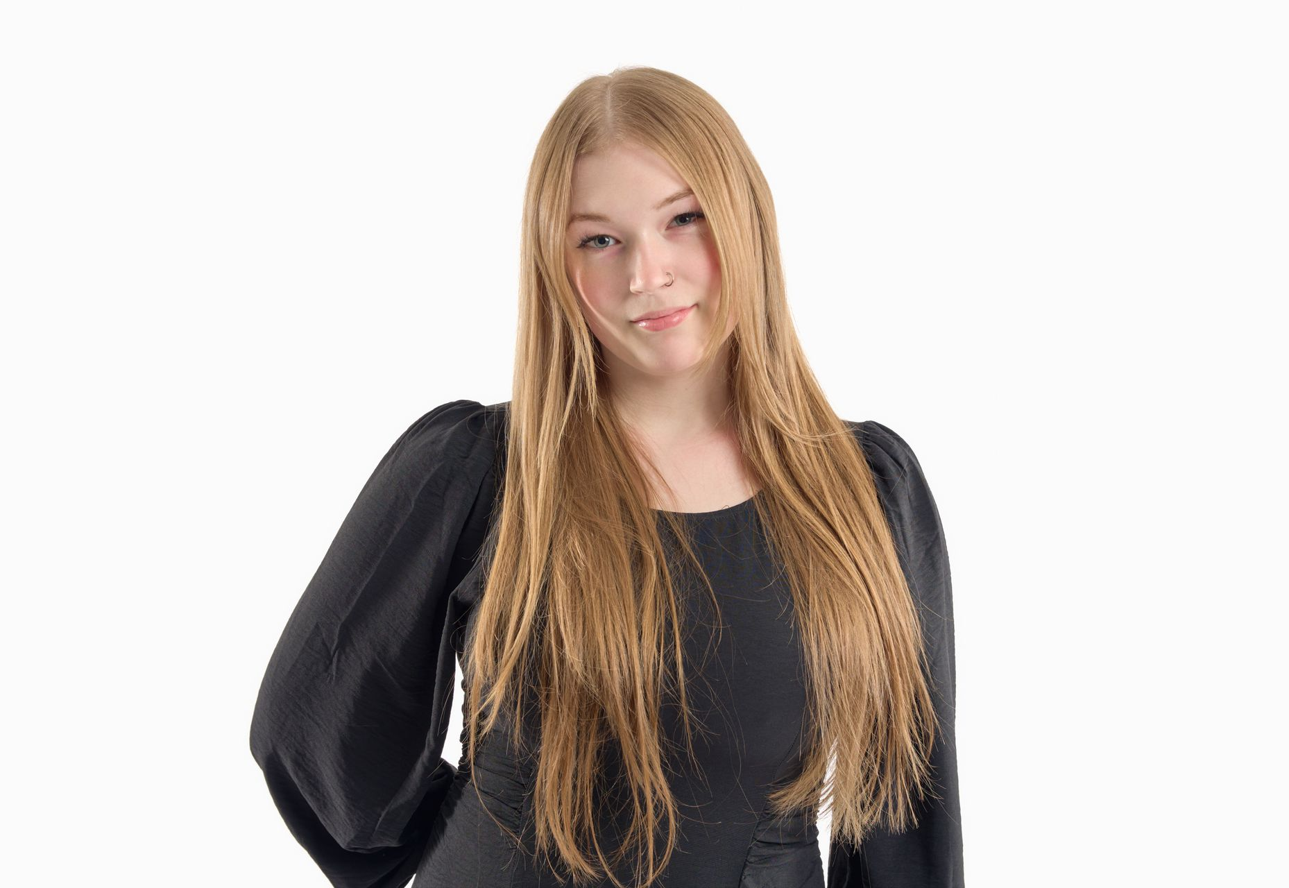 Woman in a black top posing against a white background