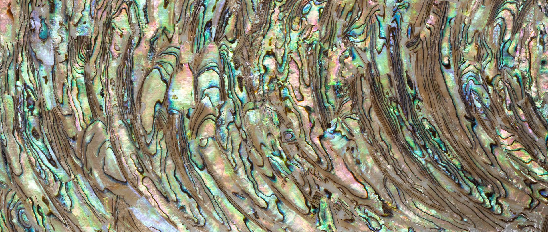 Abstract textured surface with iridescent green, pink, and purple diagonal streaks