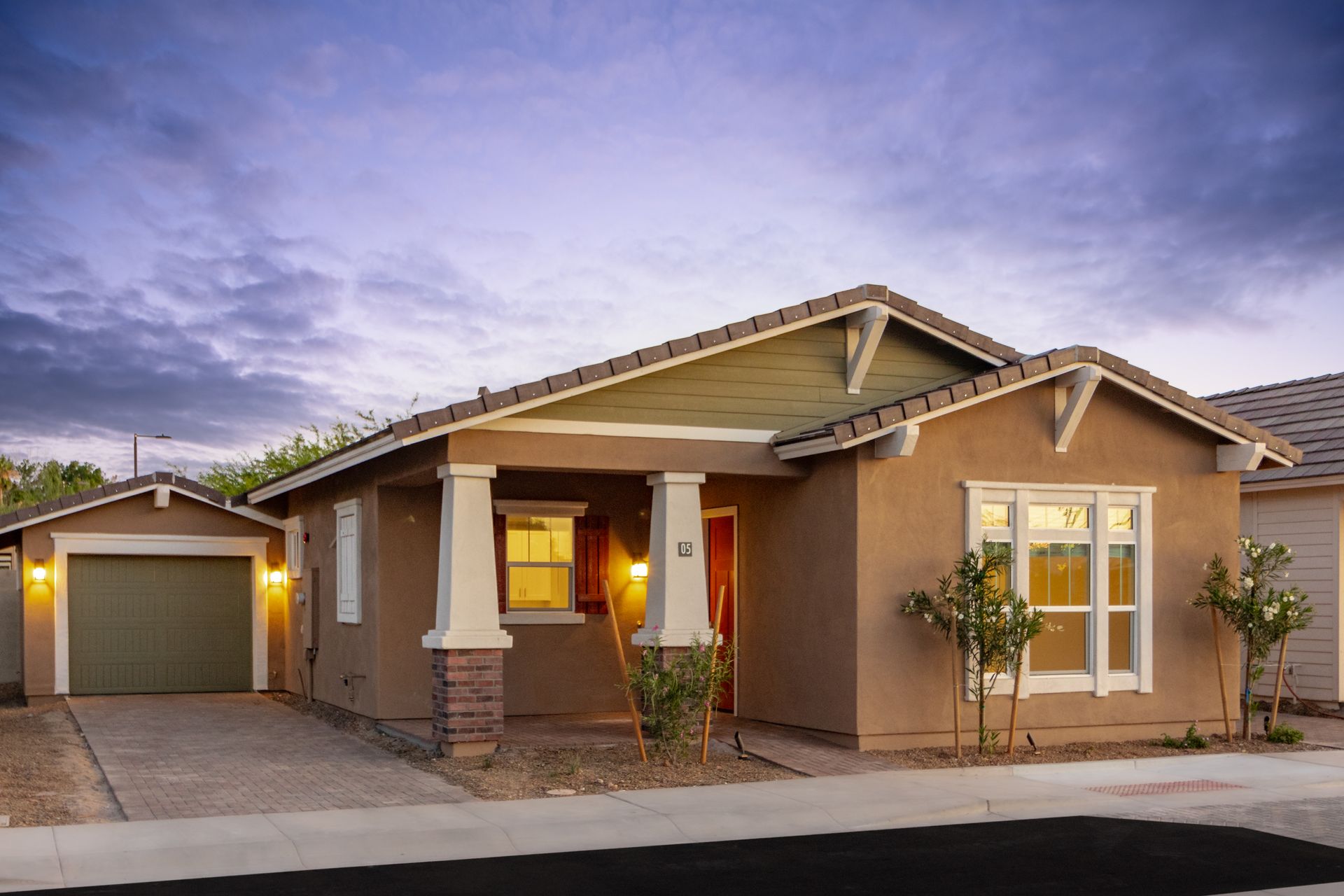 A house with a green garage door and a porch