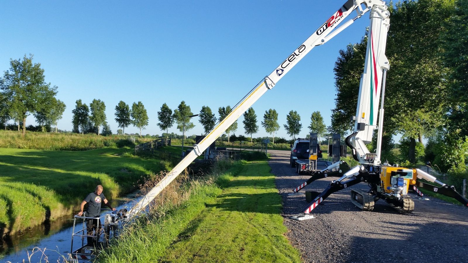 A concrete pump is being used to pump water into a river.
