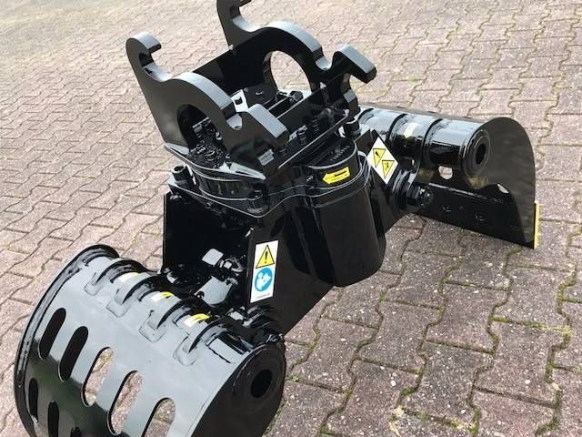A black machine is sitting on a brick sidewalk.