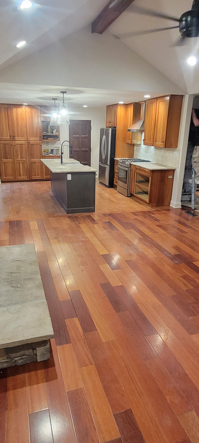 A kitchen with hardwood floors and stainless steel appliances.