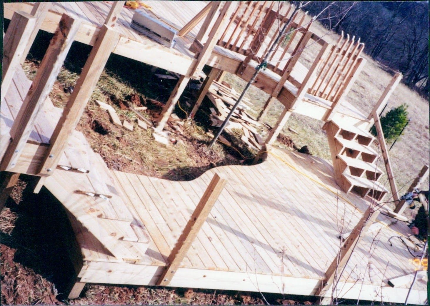 A wooden deck is being built with stairs