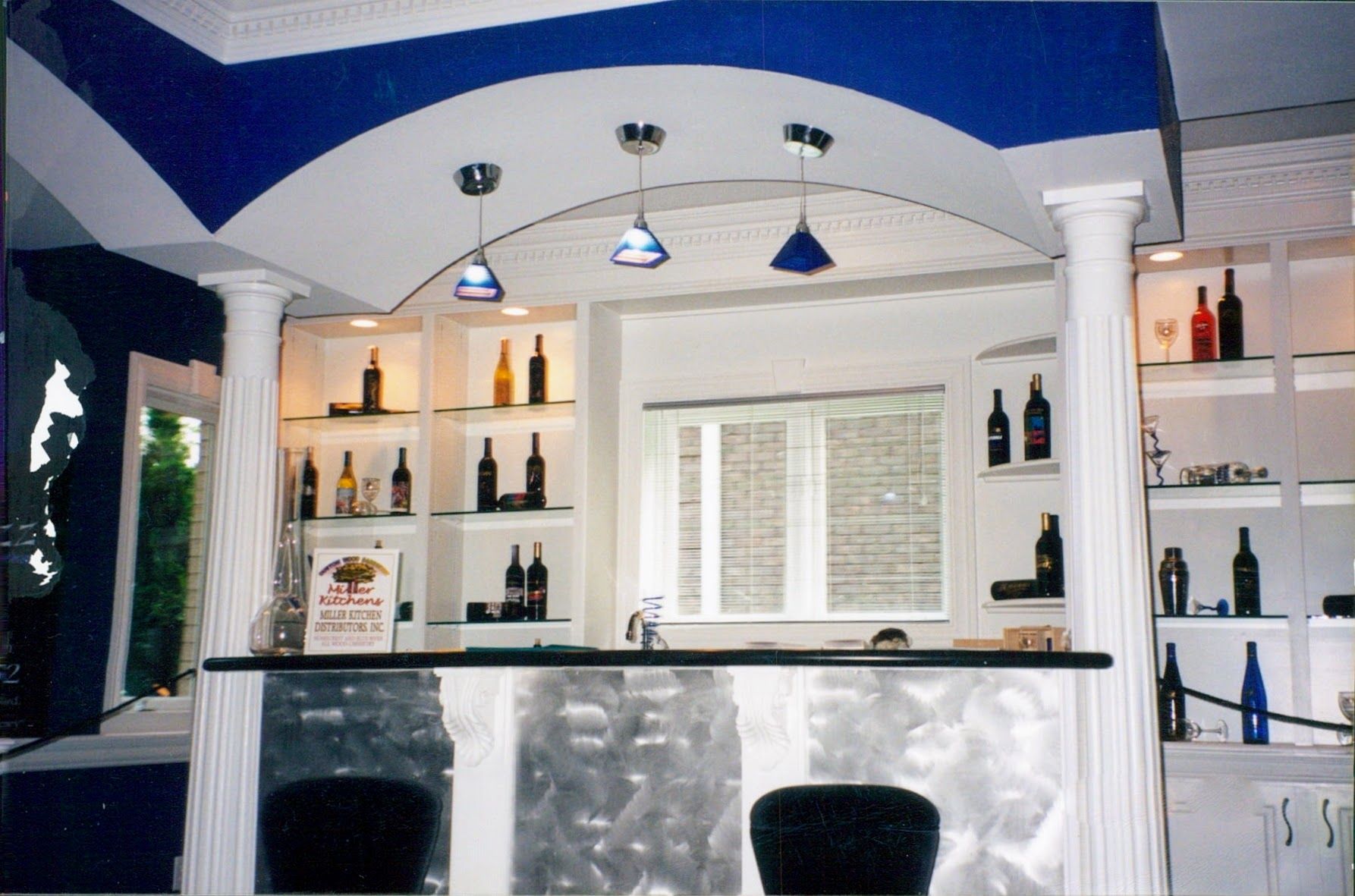 A room with a bar and bottles on shelves