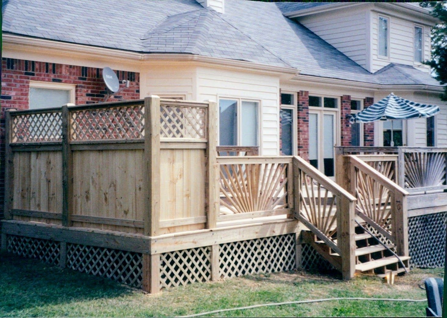 A house with a wooden deck and stairs in front of it
