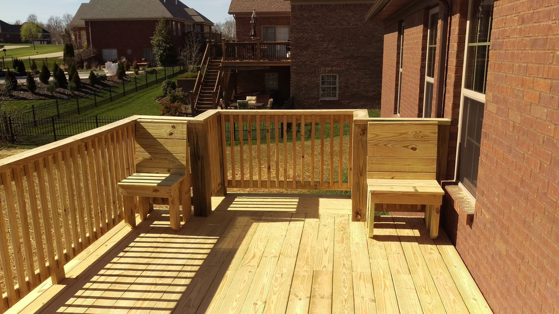 A wooden deck with a bench and a table on it