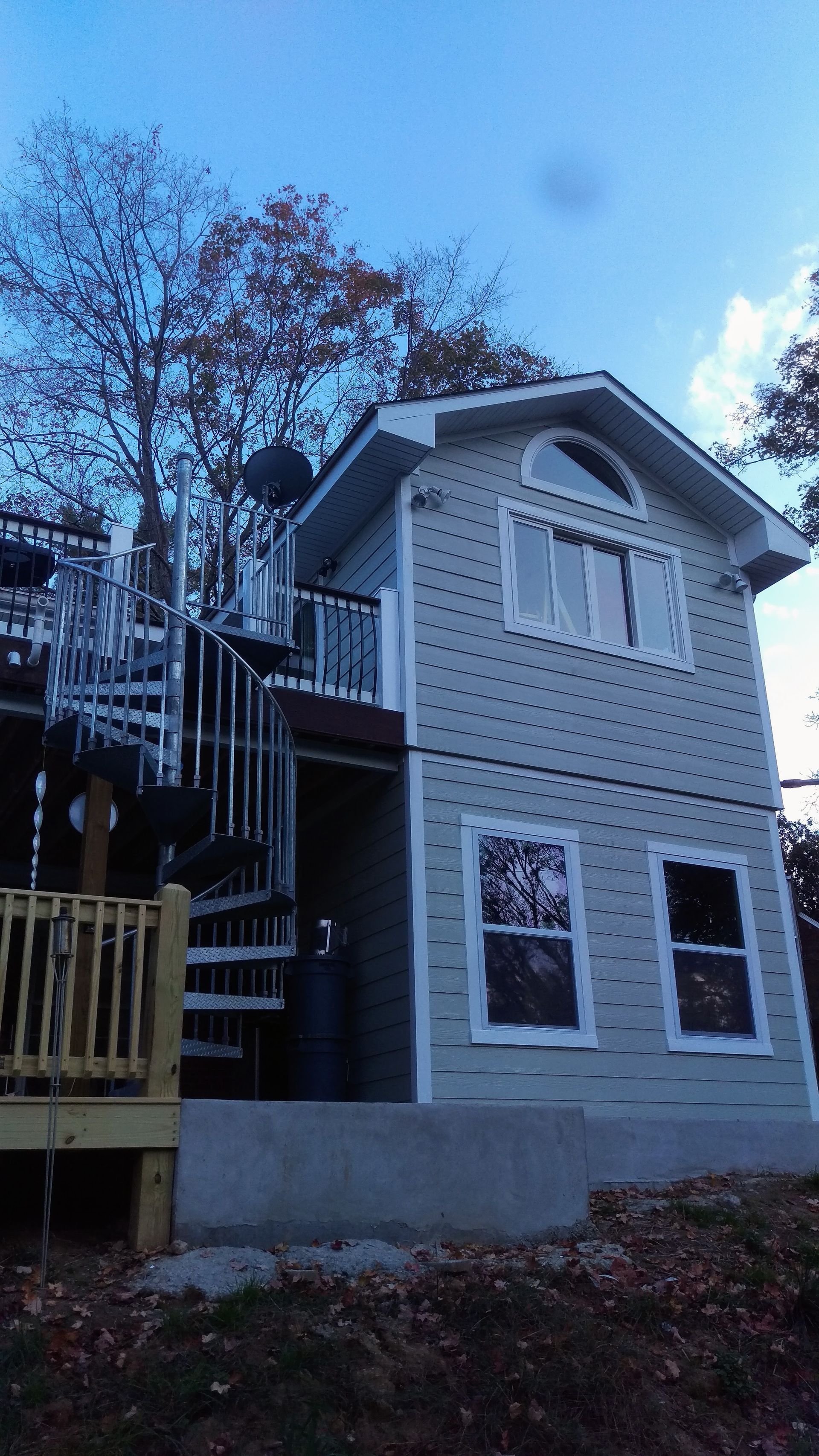 A small house with stairs leading up to the second floor