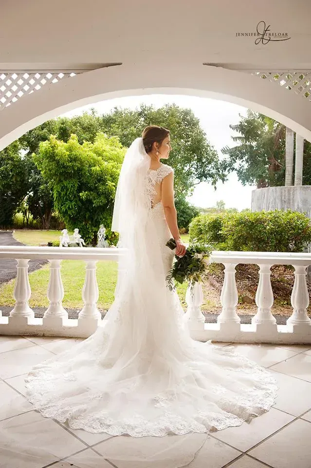 Bride in Wedding Dress, Looking Away, Holding Flowers, on a Veranda — Villa Lamor in Balberra, QLD