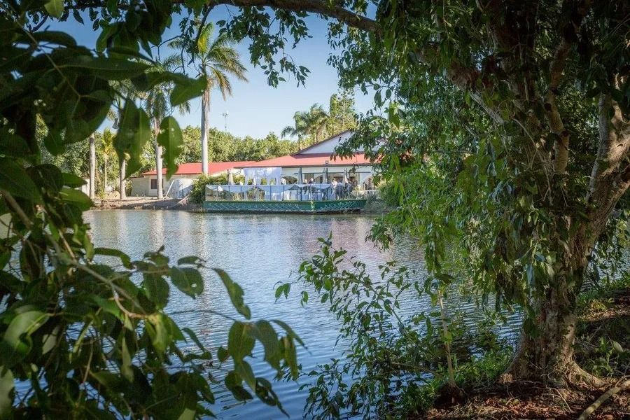 A Waterfront Restaurant With a Red Roof, Viewed Through Trees — Villa Lamor in Balberra, QLD