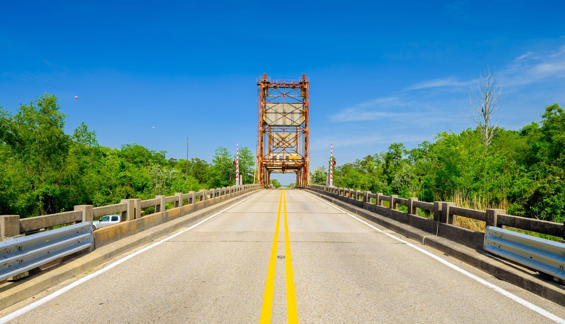 a bridge over a river with a blue sky in the background .