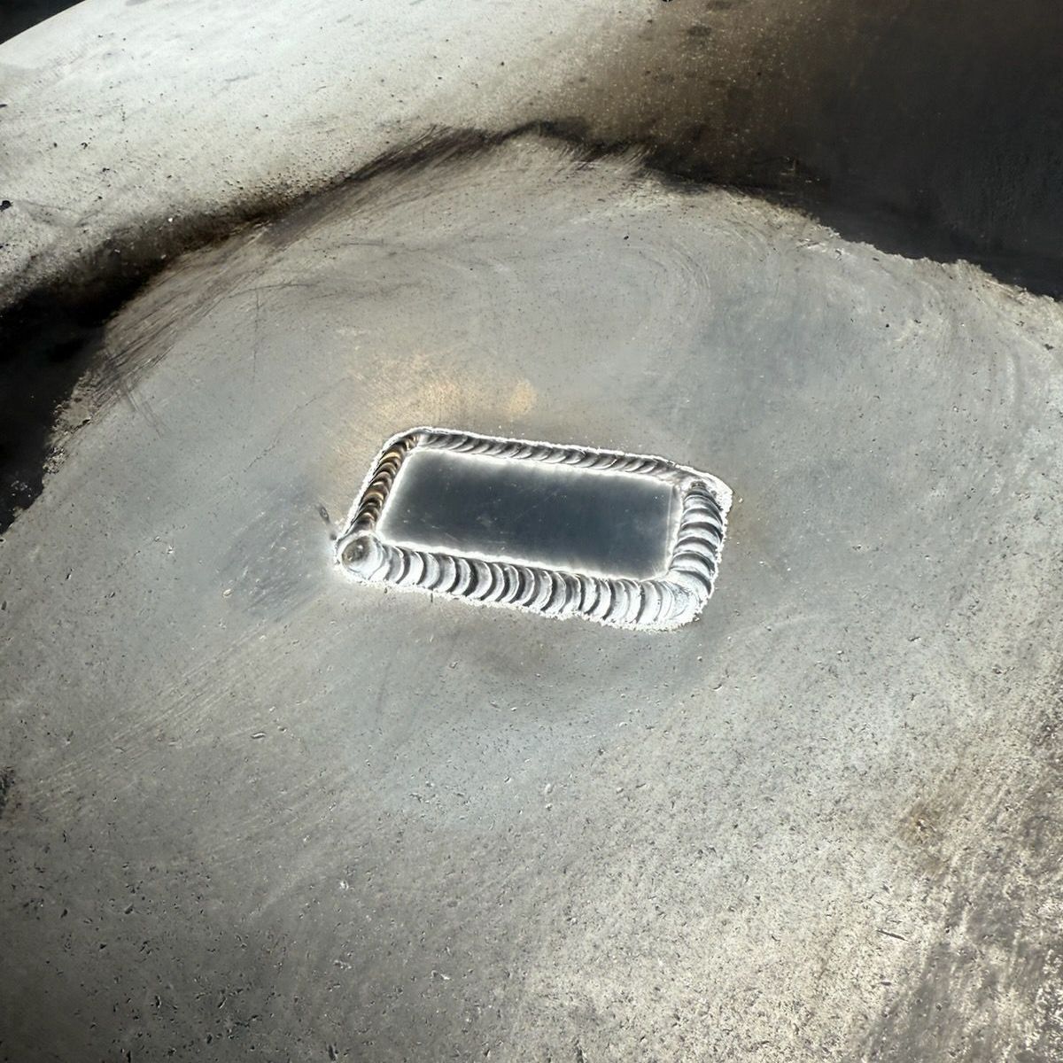 A plastic container is sitting on a concrete surface