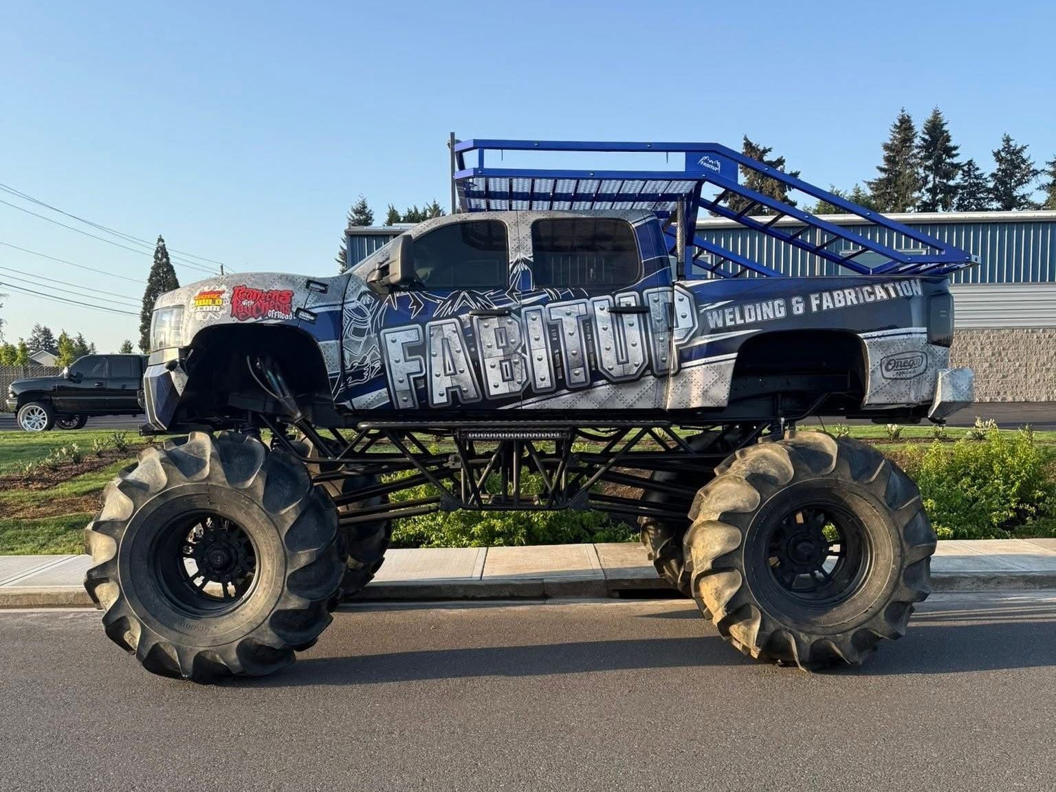 A monster truck is parked on the side of the road