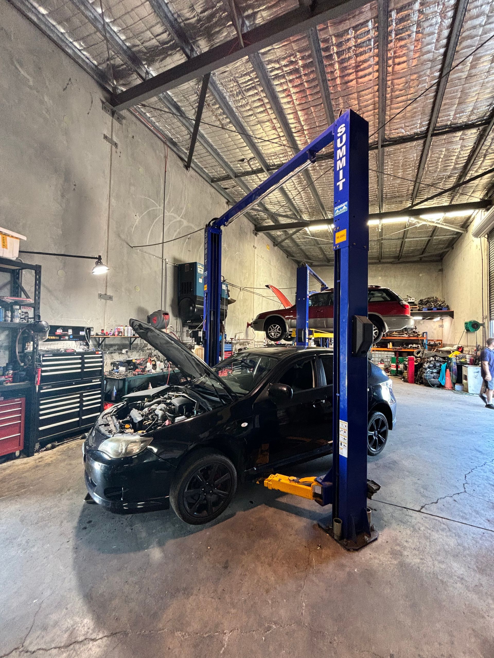 A Blue Subaru WRX Is Parked On The Side Of The Road — Subi Care Mechanical In South Murwillumbah, NSW
