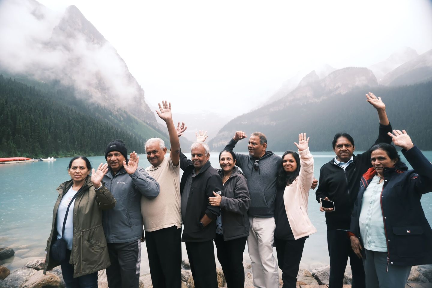 Happy group of guests at Lake Louise with Victoria Glacier backdrop, Banff Bear Travel small group tour
