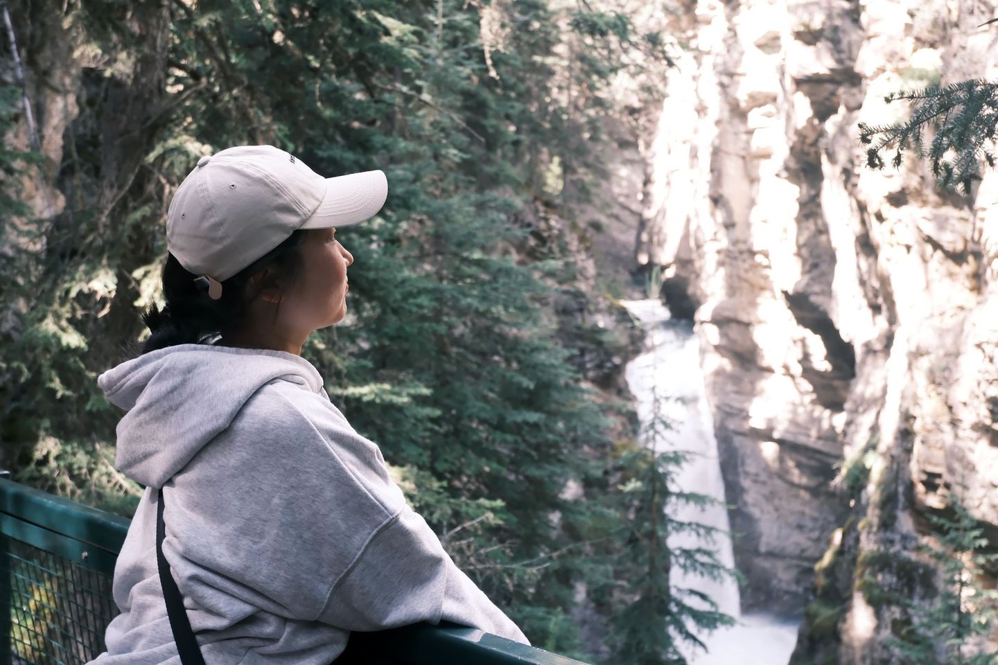 Guest at Johnston Canyon boardwalk waterfall trail, Banff Bear Travel guided hike 
