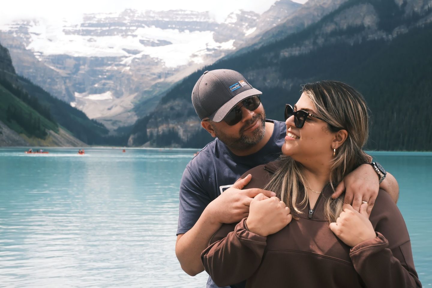 ouple portrait at Lake Louise shoreline with Victoria Glacier, Banff Bear Travel photographer guide captures your memories