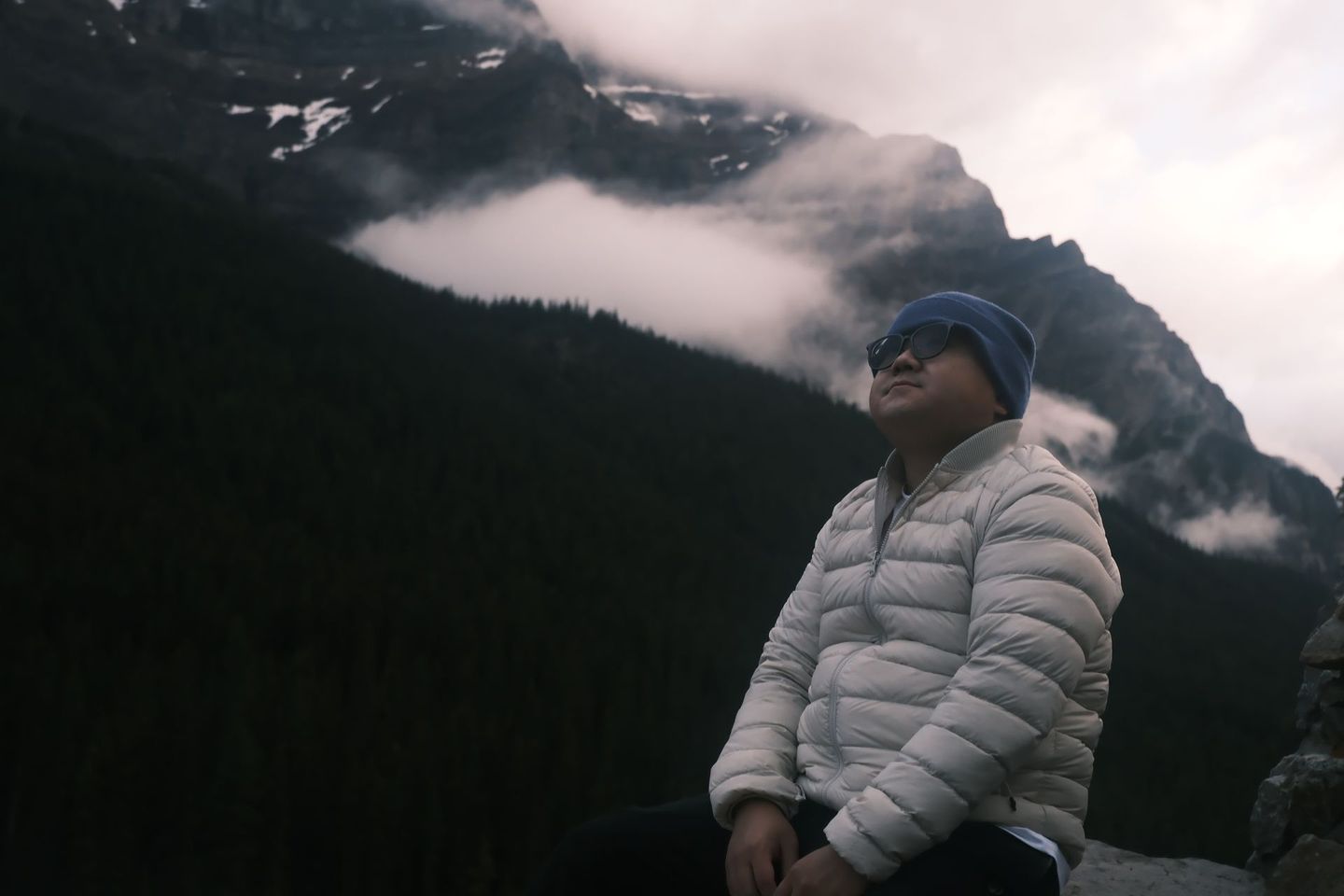 Solo traveller at Moraine Louise on a moody overcast day, Banff Bear Travel all-season Banff tours