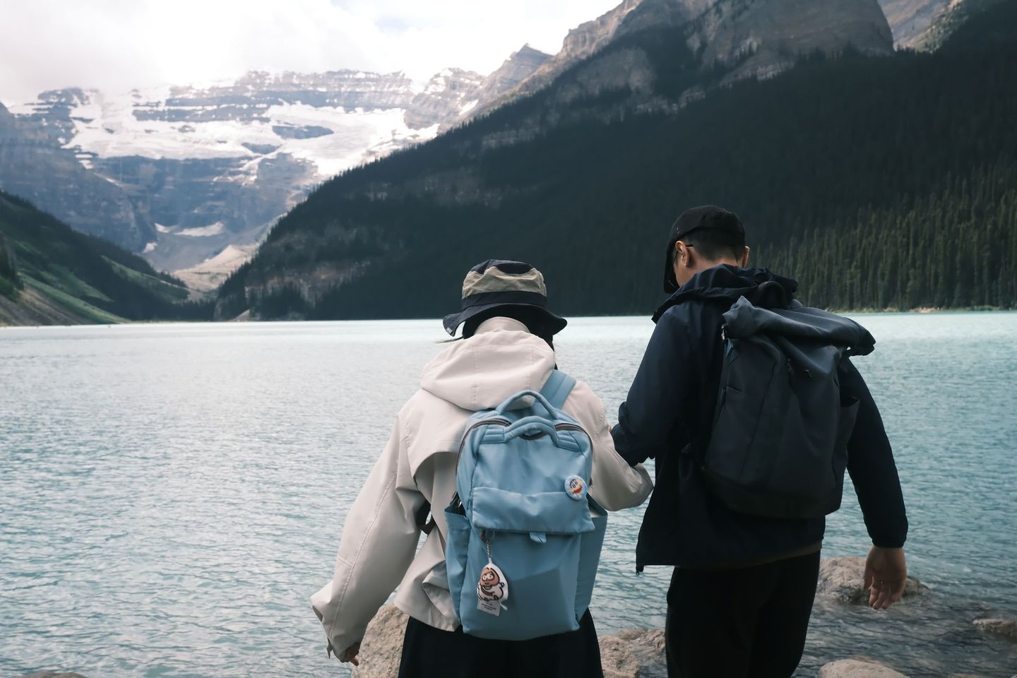Two guests at Lake Louise shoreline with Victoria Glacier, Banff Bear Travel small group photography tour
