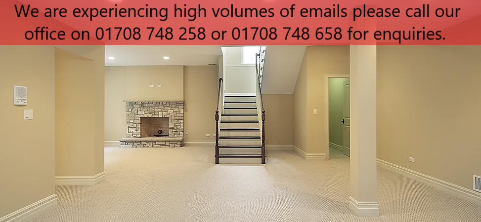 An empty room with fireplace and staircase