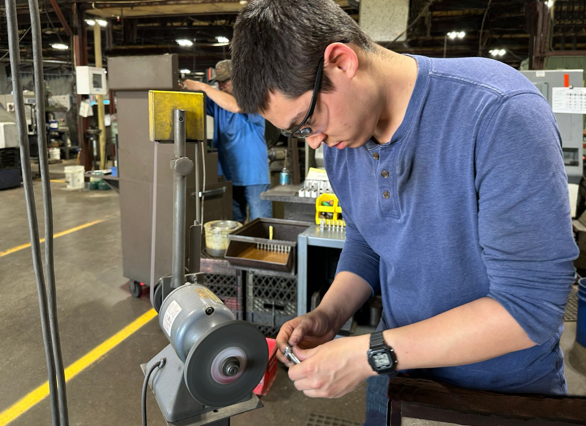A man is working on a machine in a factory.