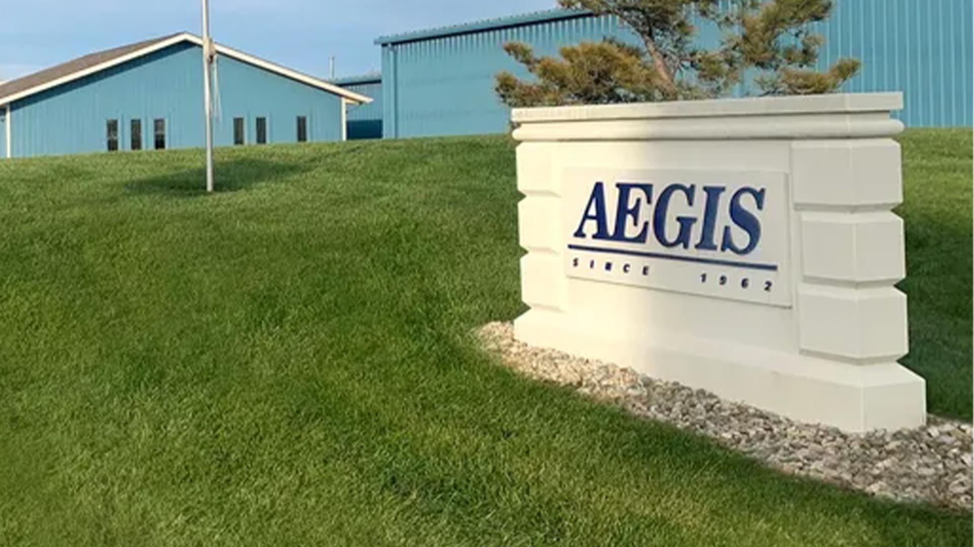 A sign that says aegis in front of a building