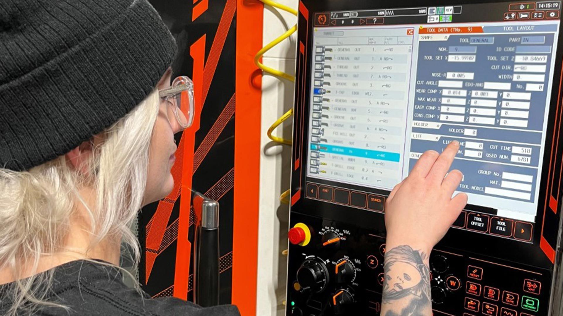 A woman is using a computer in a factory.