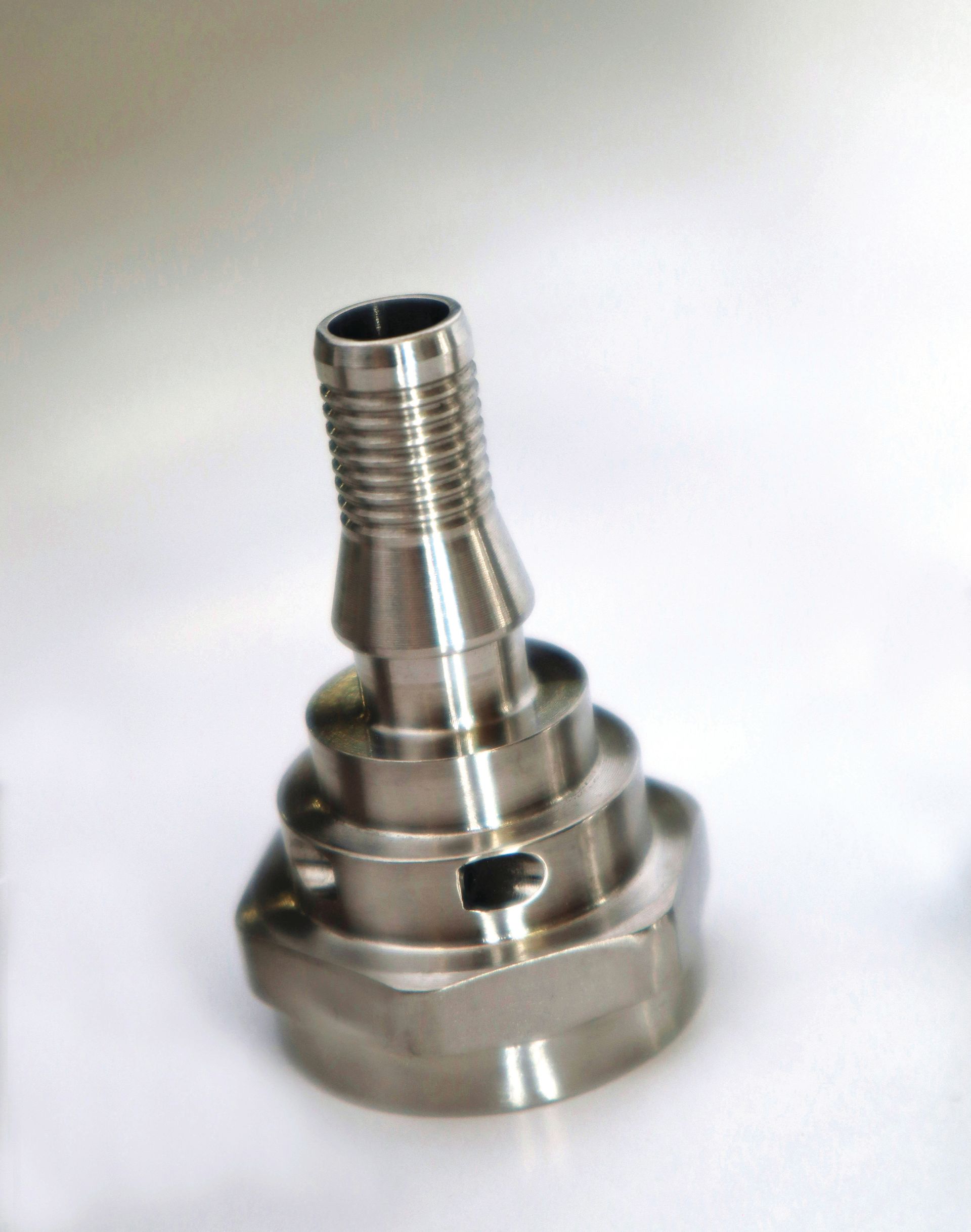 A close up of a metal object on a white surface