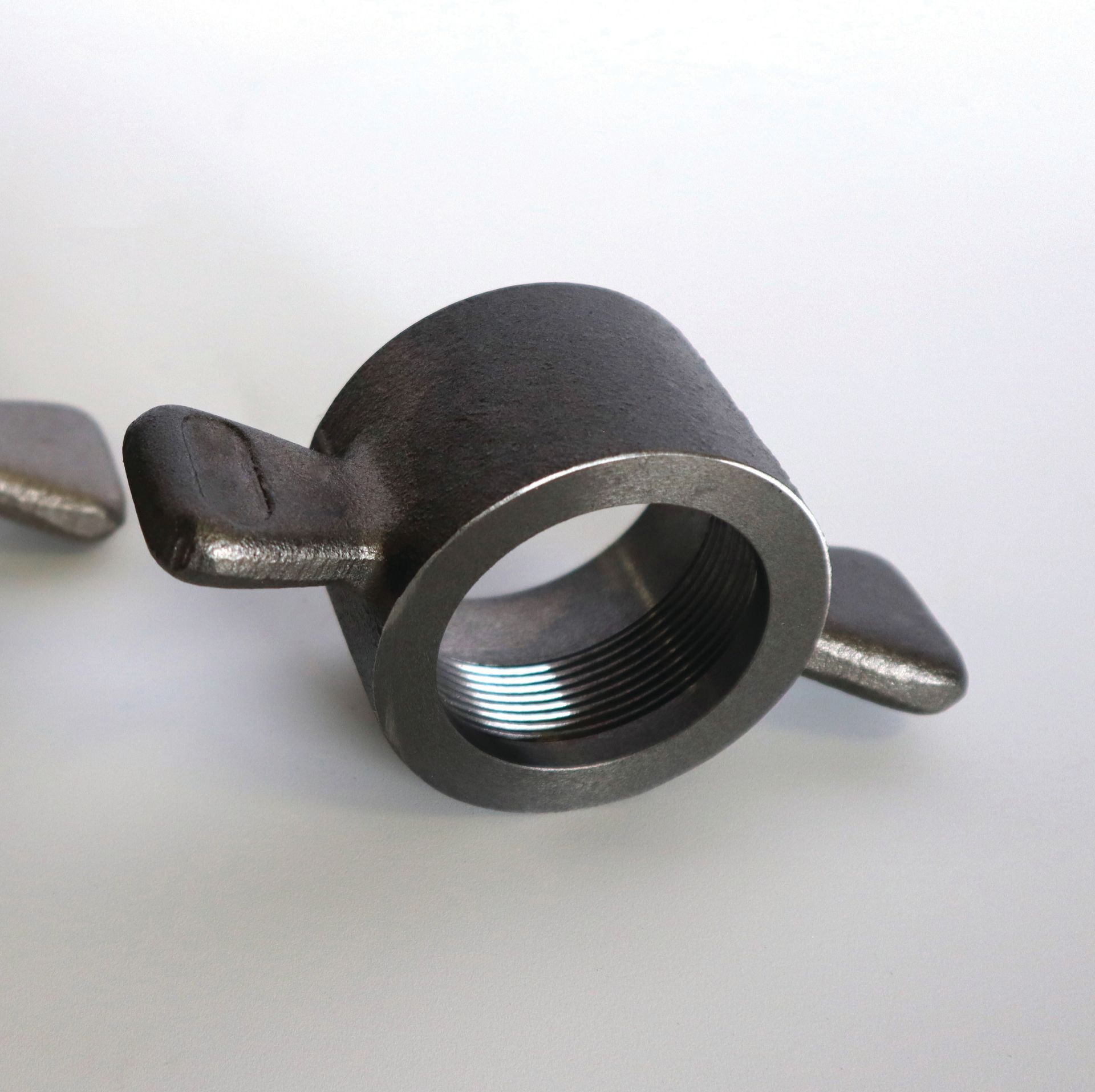 A close up of a metal object on a white surface