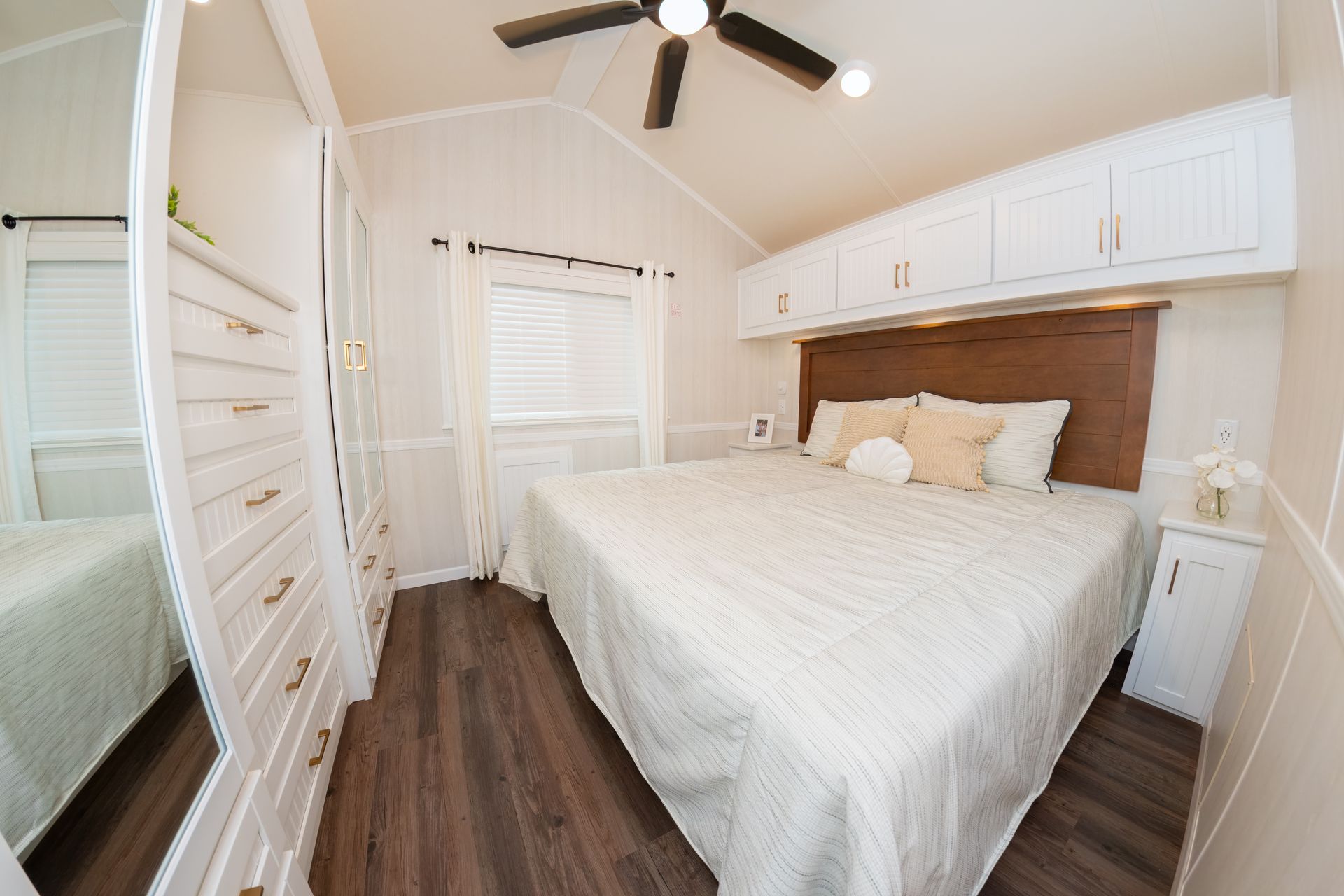 a bedroom with a large bed and a ceiling fan