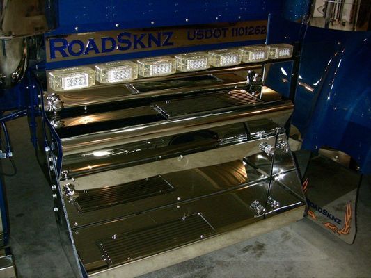 Chrome and blue RoadSkynz truck accessory with lights and storage compartments, US DOT number visible.