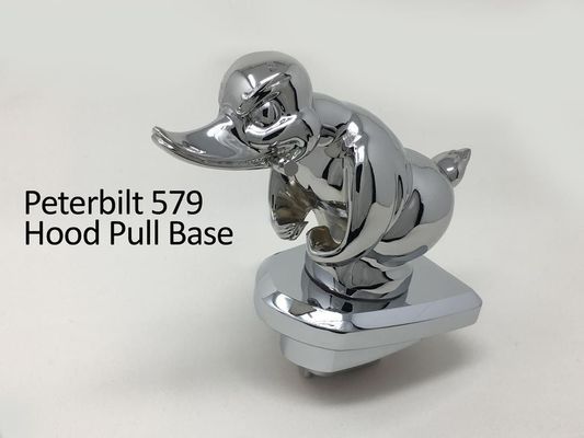 Chrome duck hood pull base for a Peterbilt 579 truck.