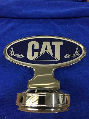 Chrome CAT emblem with blue background, silver text, and flame details.