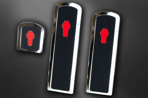 Three chrome and black truck door lock covers with red logo.