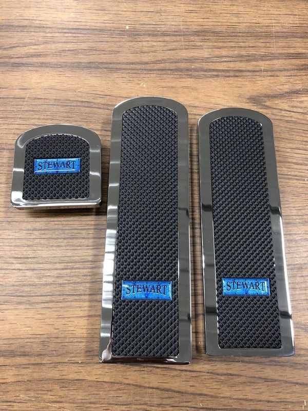 Three automotive pedal pads with black mesh and