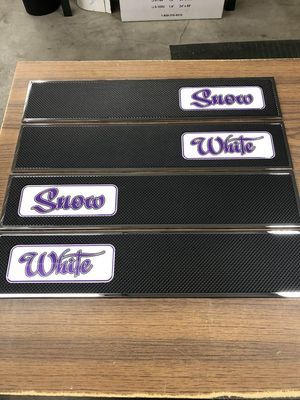 Four black rectangular plates with silver borders and white/purple text: