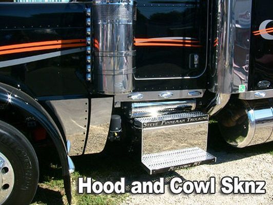 Chrome details on black semi-truck, with orange stripes. 