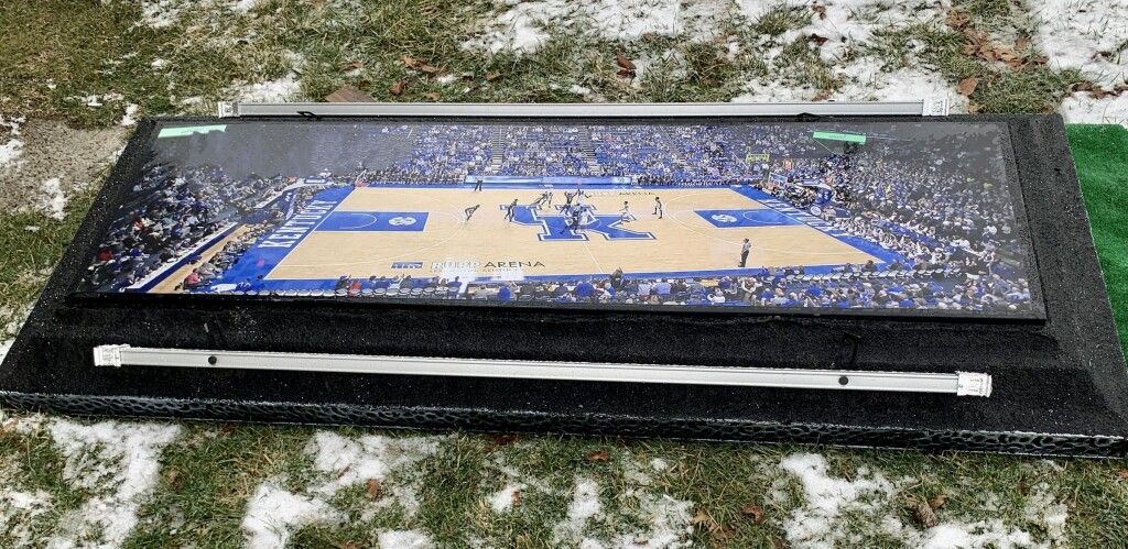A picture of a basketball court on a snowy field