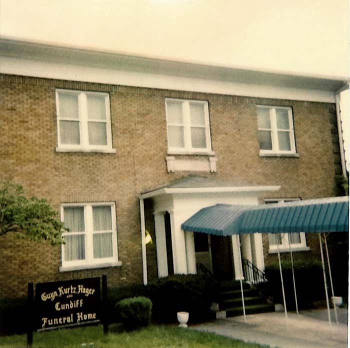 A brick building with a sign that says funeral home
