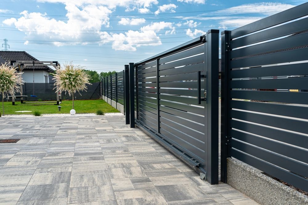 A Modern Gray Sliding Gate and Fence — Smiddy's Services In Terrigal, NSW