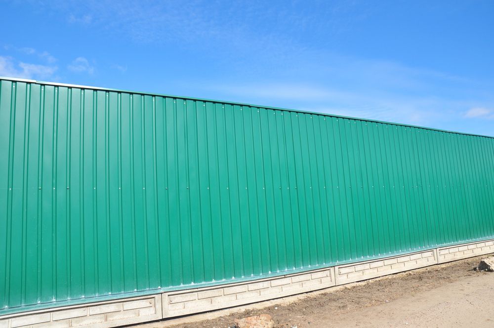 A Green Corrugated Metal Fence — Smiddy's Services In Terrigal, NSW