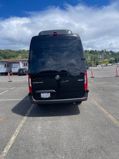 A black van is parked in a parking lot.