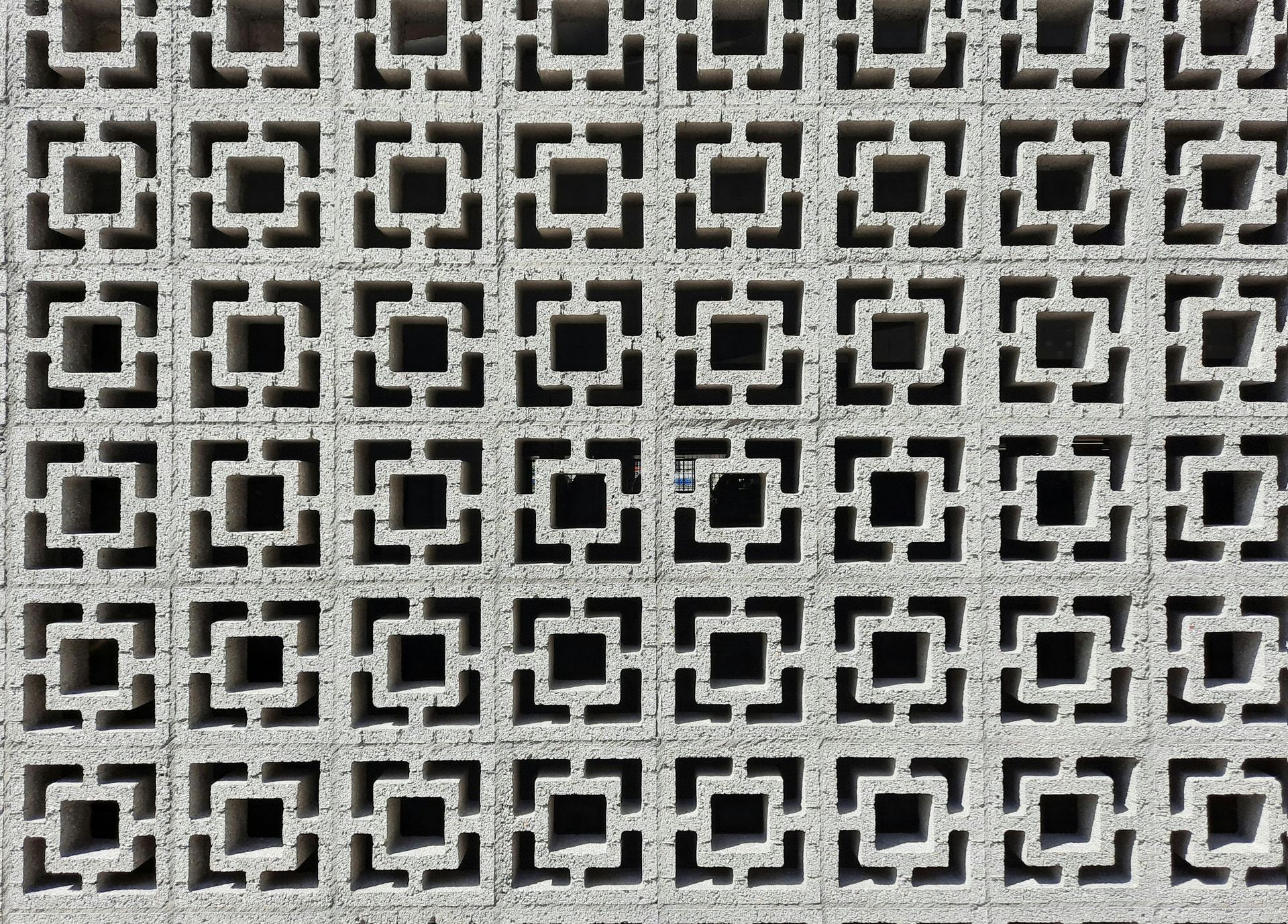 Repeated black and white geometric square pattern on a tiled surface