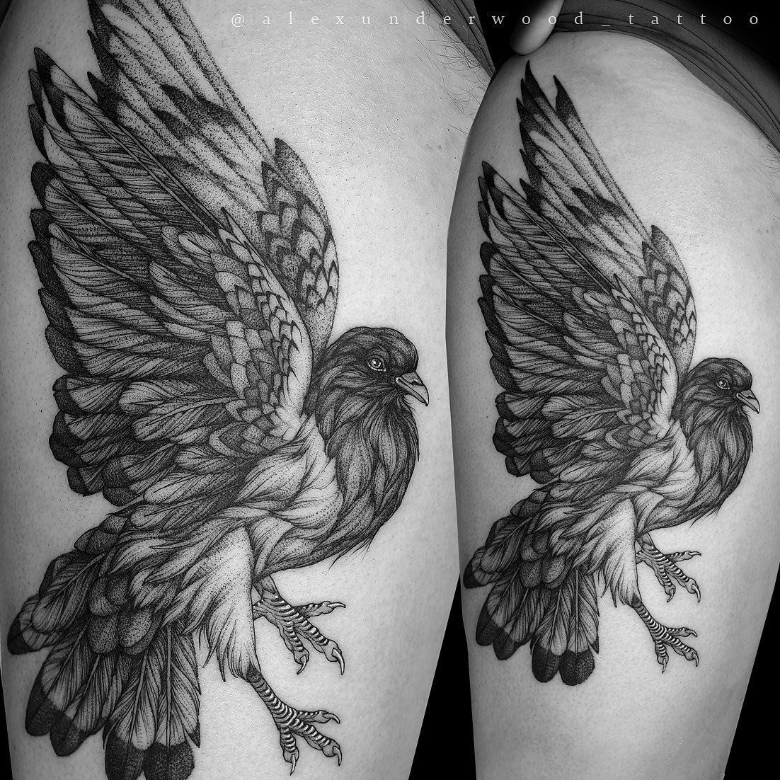 A black and white tattoo of a bird on a person 's leg