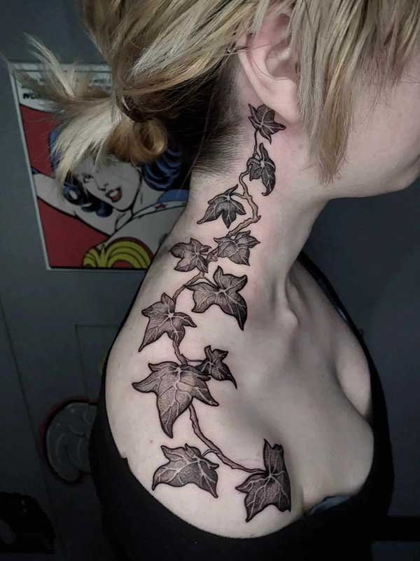 A woman has a tattoo of ivy on her neck and shoulder