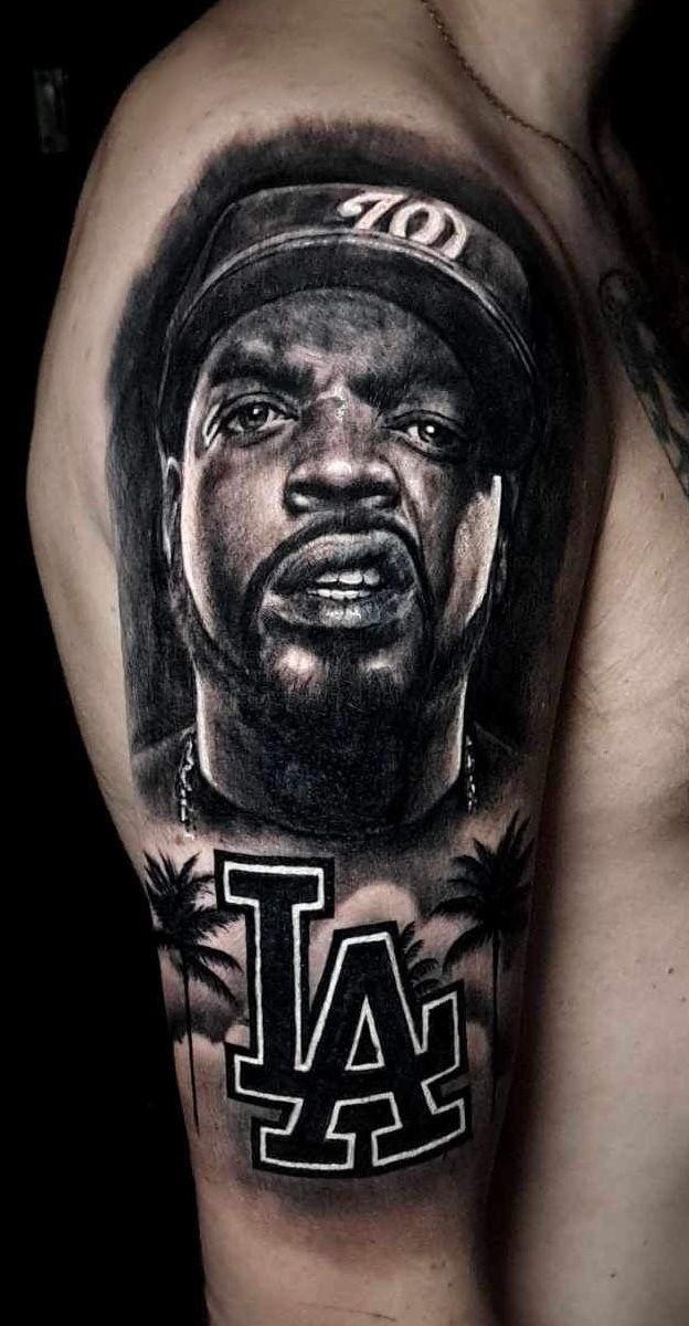 Black-and-gray tattoo of a baseball player in a LA cap with the LA Dodgers logo below