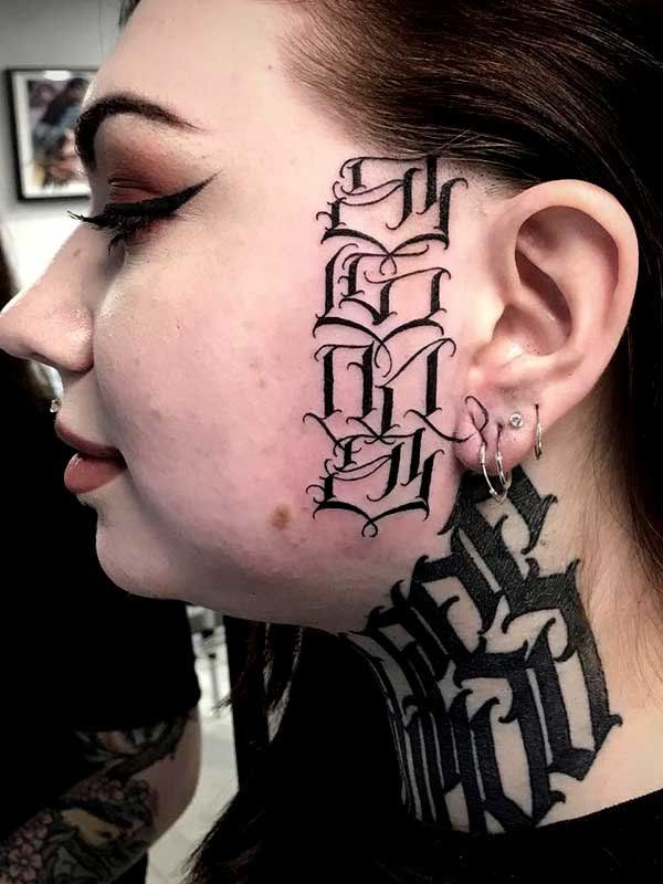 A woman has a tattoo on her face and neck.