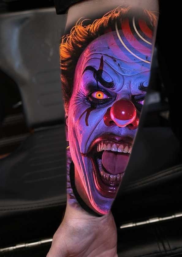 A person has a tattoo of a clown on their arm.