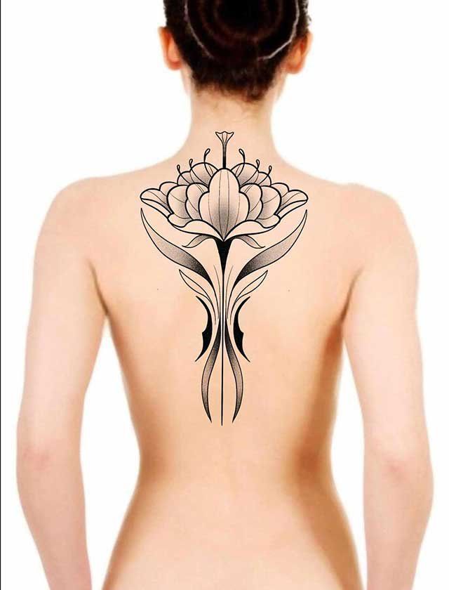 A woman has a tattoo of a flower on her back
